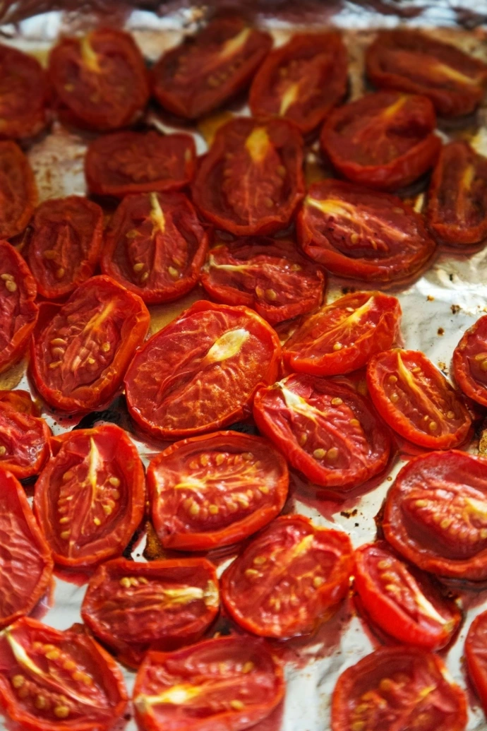 A pan filled with sliced tomatoes on top of a table
